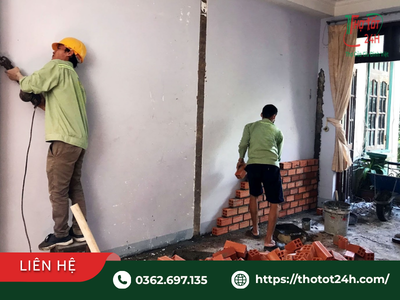 Thợ thi công đục mở tường và xây tô cải tạo không gian trong quy trình sửa nhà trọn gói cho nhà cấp 4 xuống cấp.
